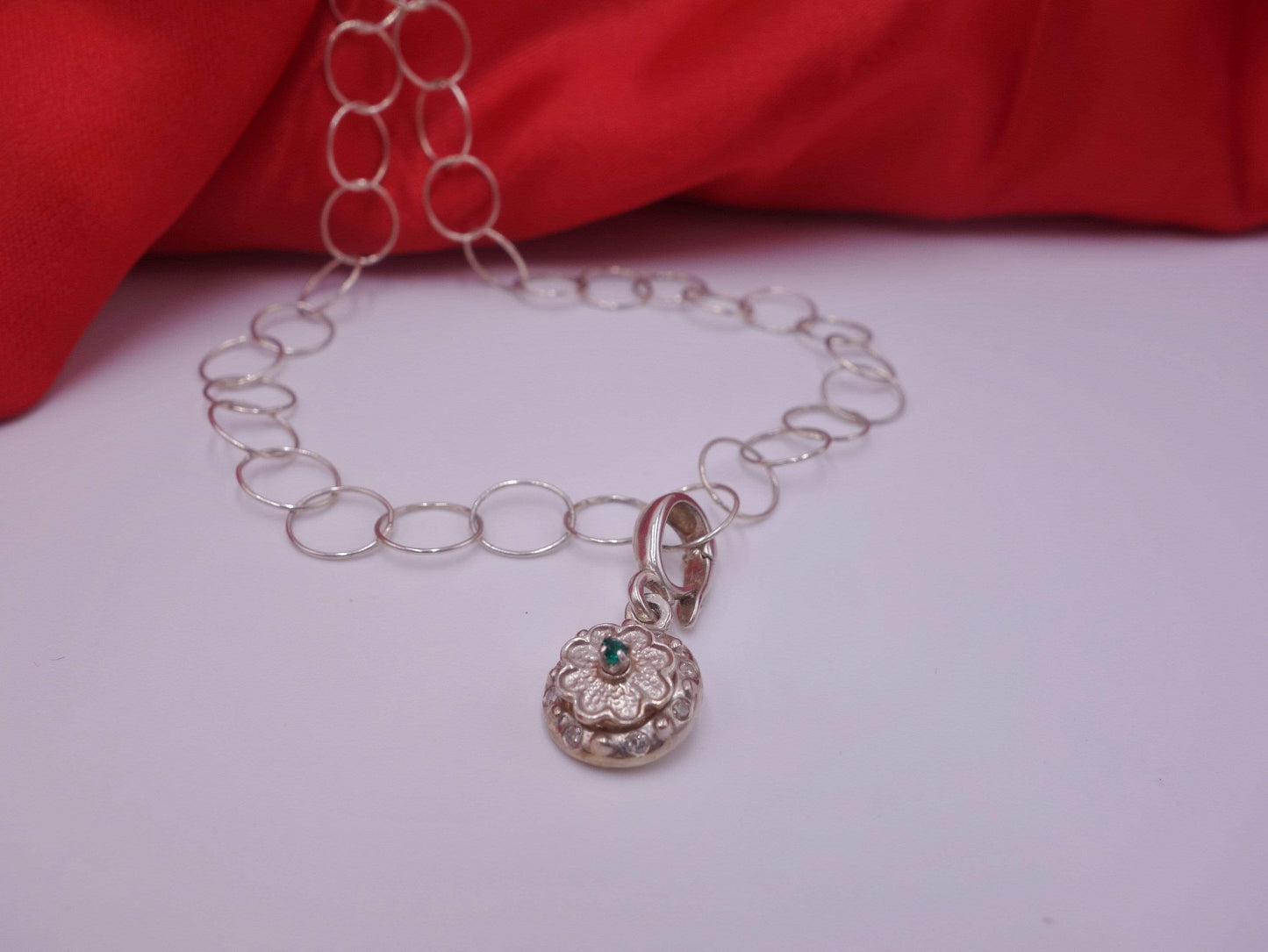 Rotating Silver Flower with Green Emerald Center with Diamonds