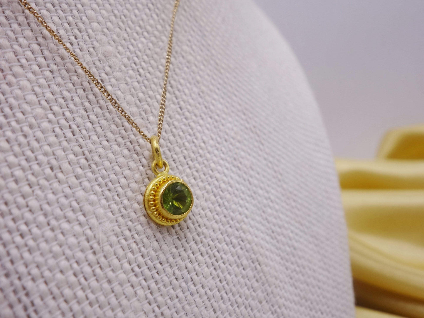 Hand formed 22kt gold peridot pendant