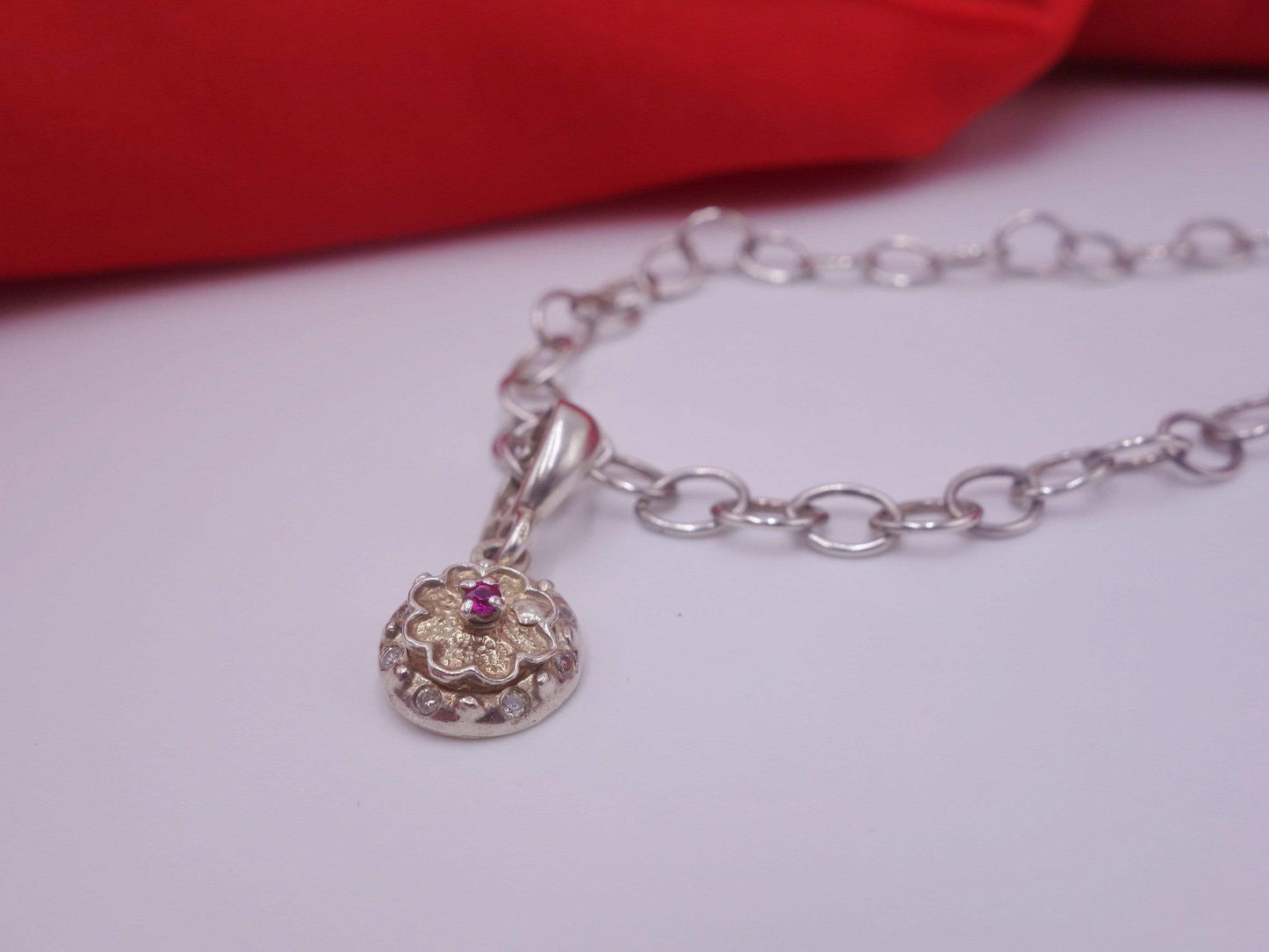 Rotating Silver Flower with Pink Topaz Center with Diamonds