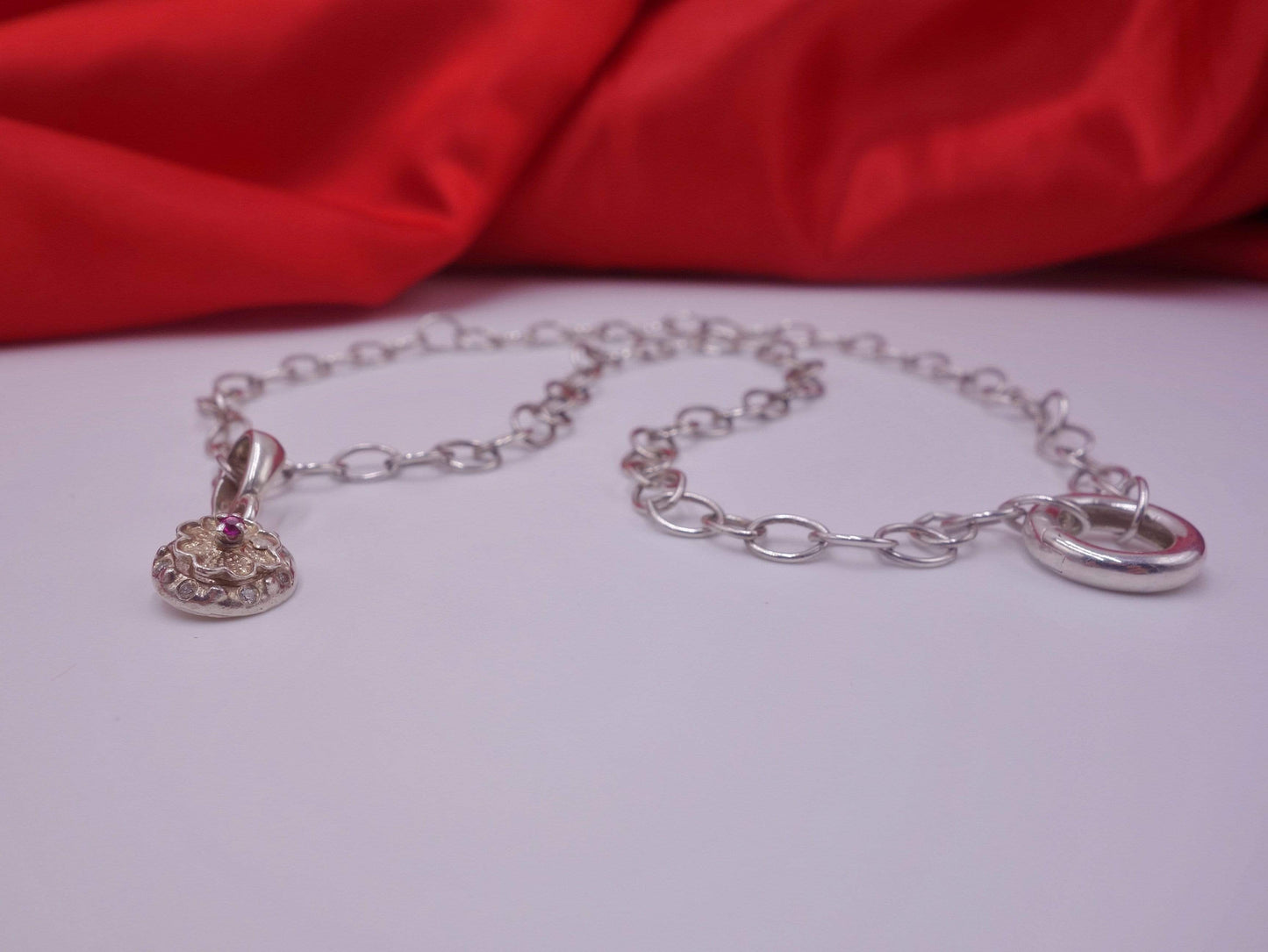 Rotating Silver Flower with Pink Topaz Center with Diamonds