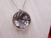 Silver pendant with personalized items enclosed