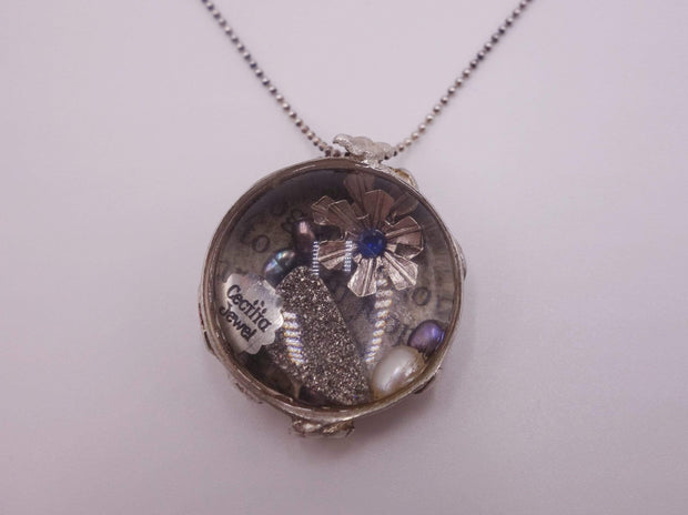 Silver pendant with personalized items enclosed