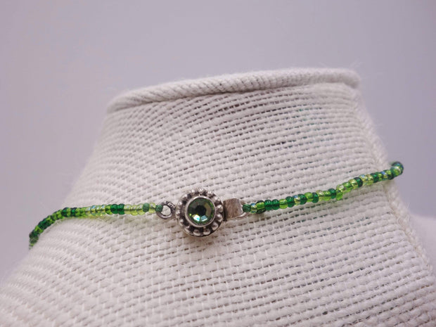 Delicate peridot necklace with a front fastening clasp