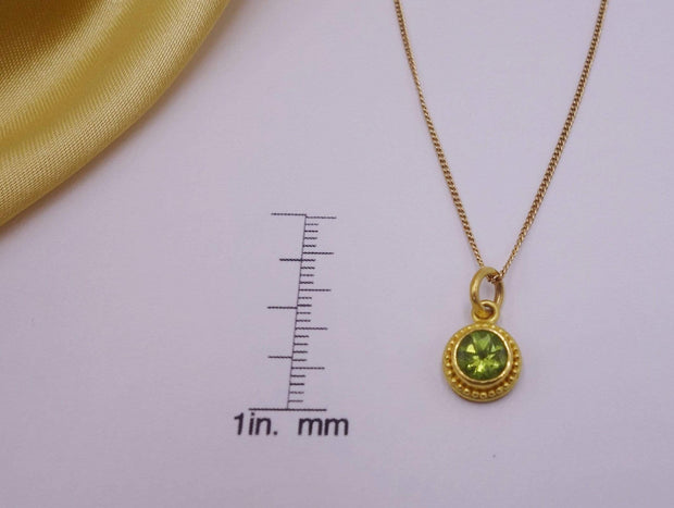 Hand formed 22kt gold peridot pendant 