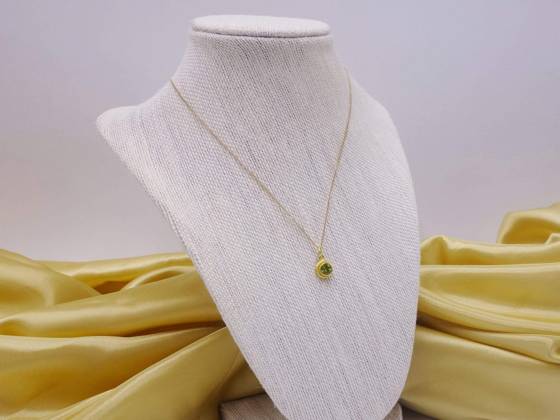 Hand formed 22kt gold peridot pendant 